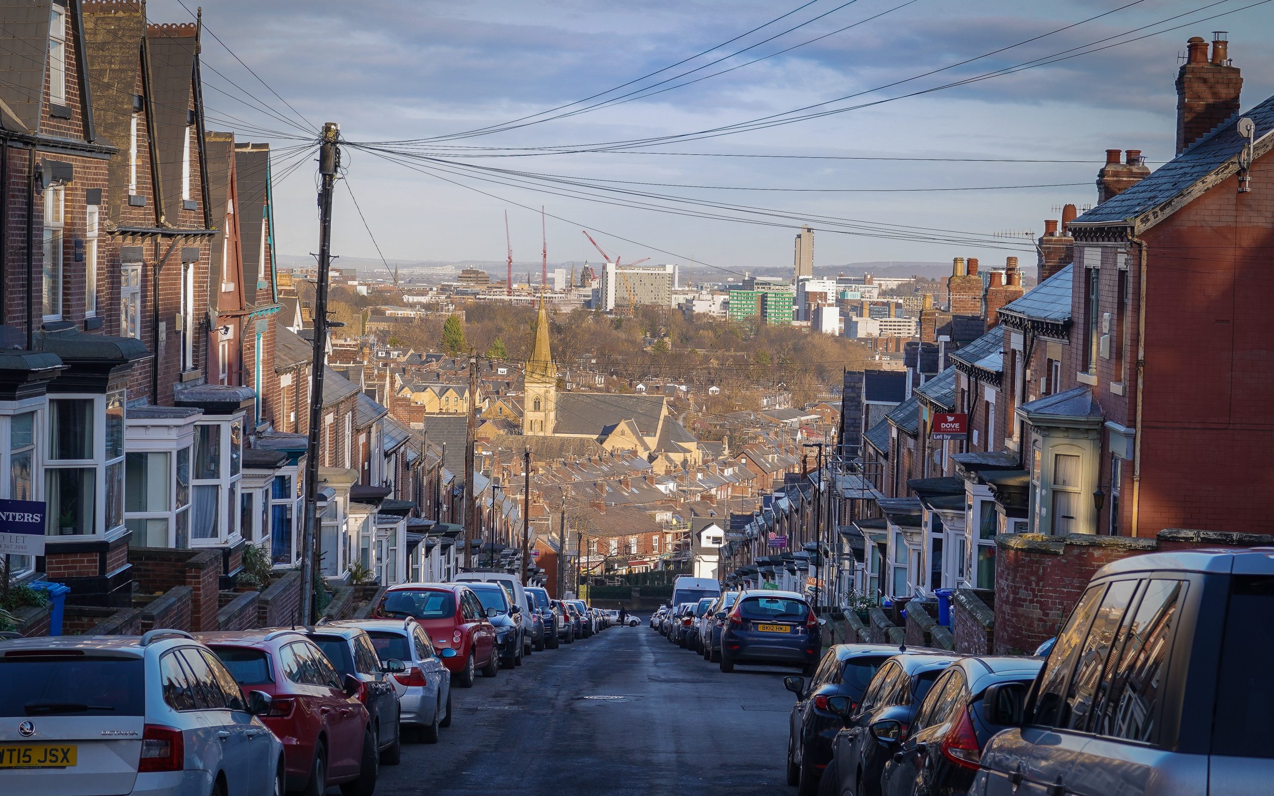 Looking down street packed with a cars