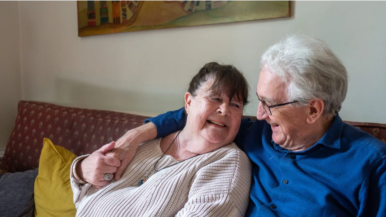Older couple sat on sofa