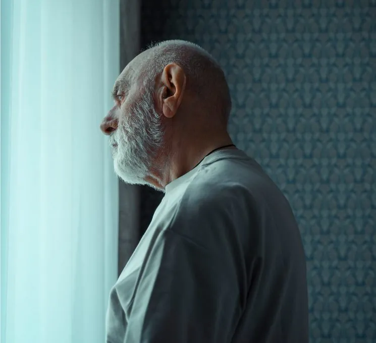 Old man looking out of window